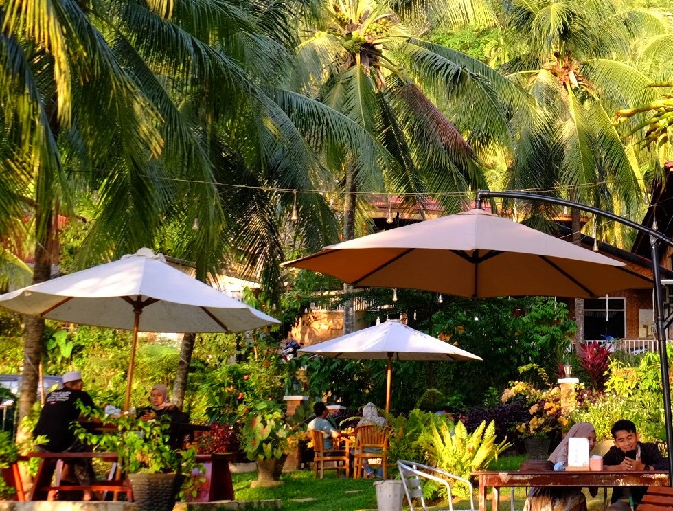 the front yard green garden with people enjoying at airmanis hillside retreat padang west sumatra
