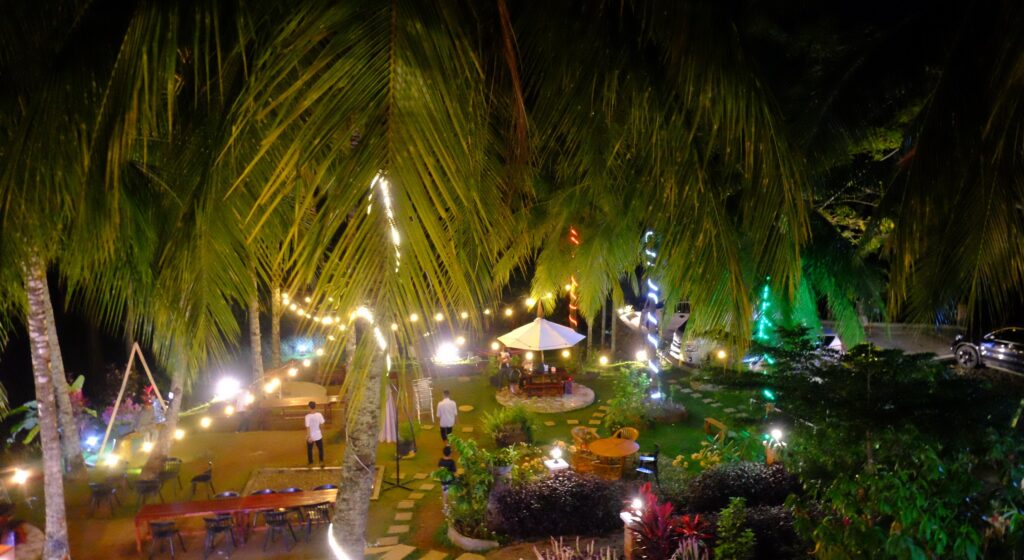 the illuminated flowery front yard garden at night time at airmanis hillside retreat padang west sumatra