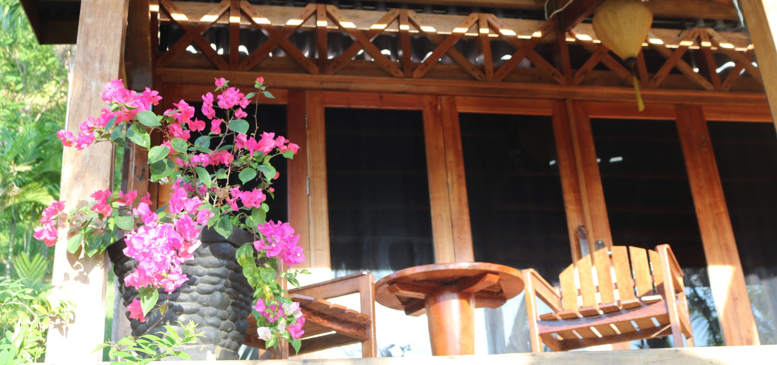 the wooden double storey main house terrace at airmanis hillside retreat padang west sumatra